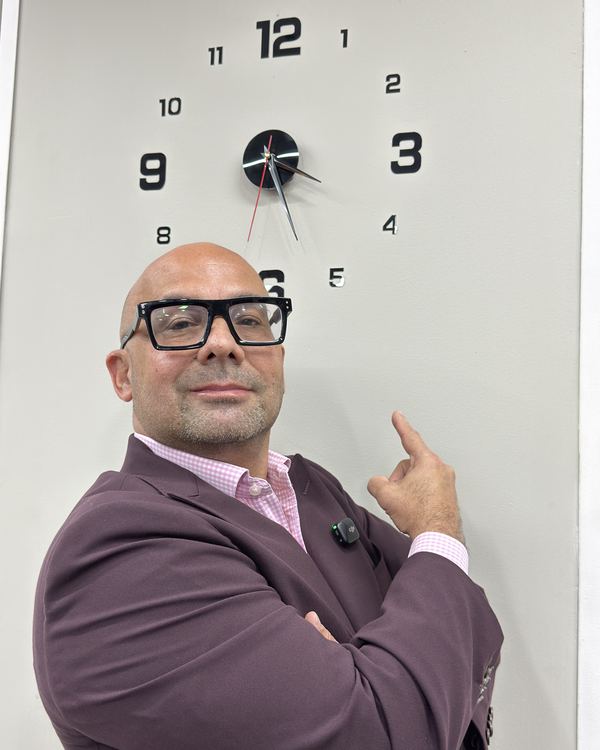 El Dr. Morales señala un reloj de pared: el despacho atiende a cualquier hora